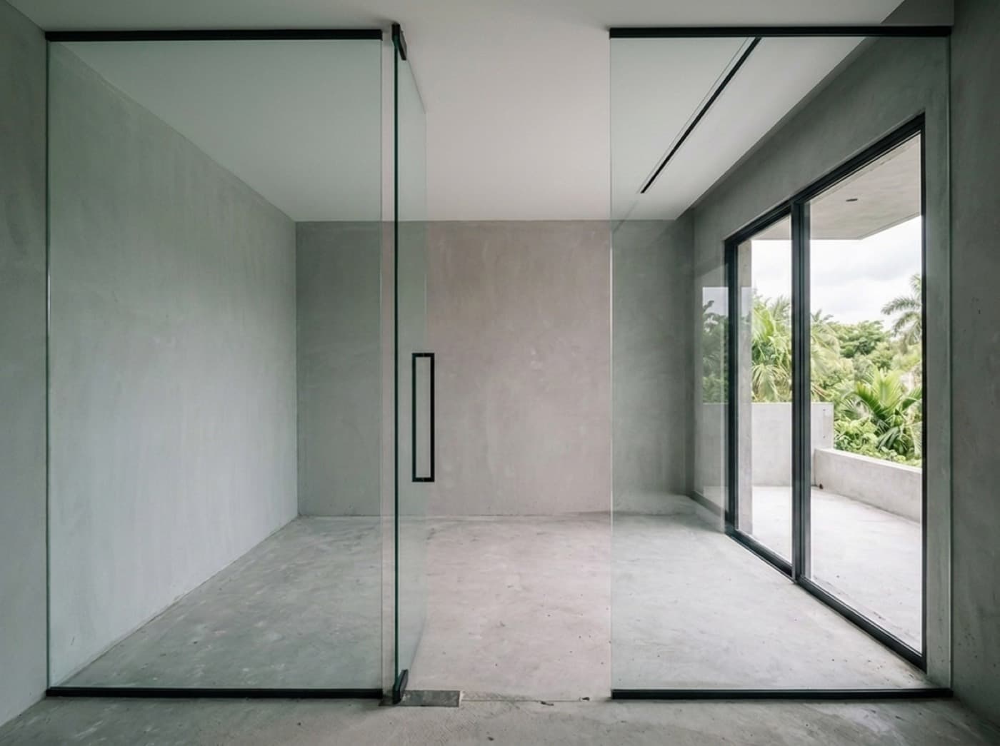 Concept visualization: the same room with tall frameless glass panels seated into the frames and a glass partition